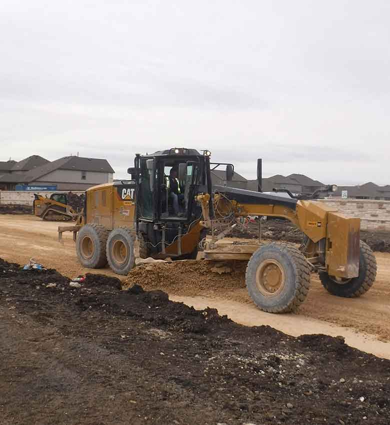 Tractor on the land with mud area