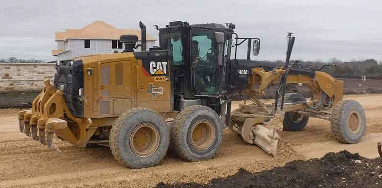 Tractor on the land with mud area